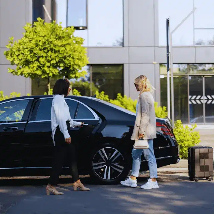 A client getting into a clean, private car with luggage